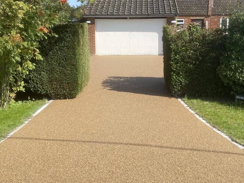 Hedge-lined driveway — resin bound project by National Surfacing